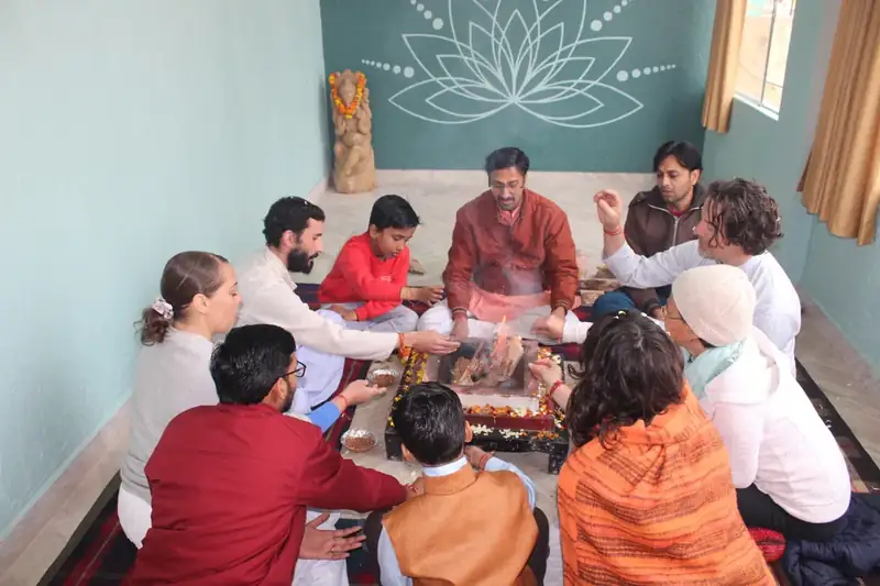 Group seated around the sacred fire during a havan ceremony at Sri Yoga Ashram