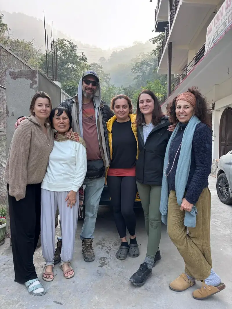 Group of students standing outside the Sri Yoga Ashram building in the Rishikesh hills